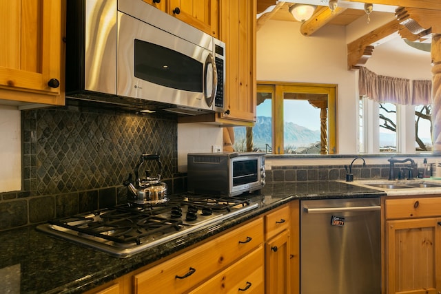6816 Nagoya Rd NE, Rio Rancho, NM 87144 - kitchen featuring sink, tasteful backsplash, dark stone countertops, appliances with stainless steel finishes, and a mountain view