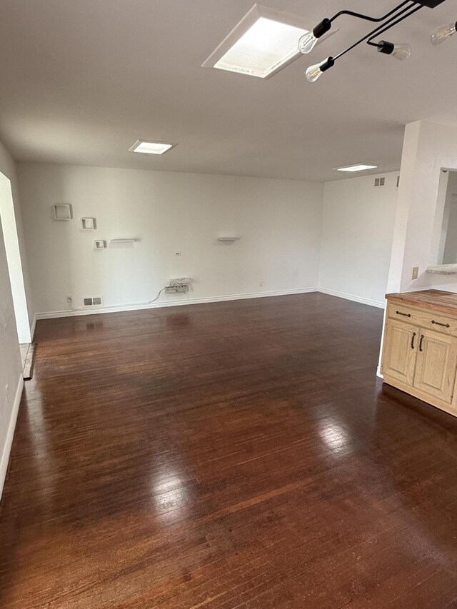 spare room featuring dark hardwood / wood-style floors