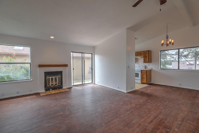 unfurnished living room featuring hardwood / wood-style flooring, vaulted ceiling, and a healthy amount of sunlight