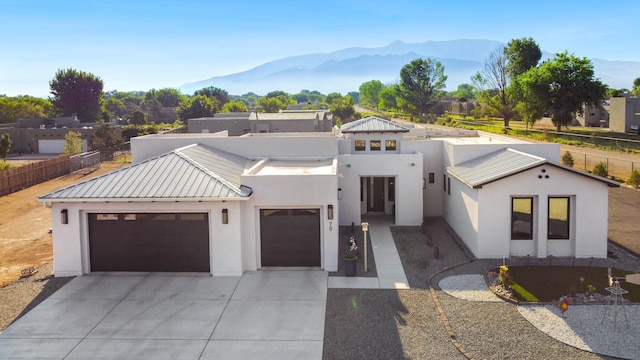 view of front of property featuring a garage and a mountain view