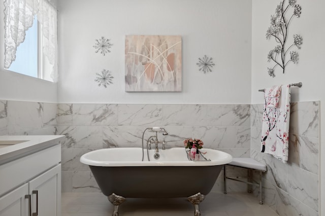 bathroom featuring a washtub and vanity