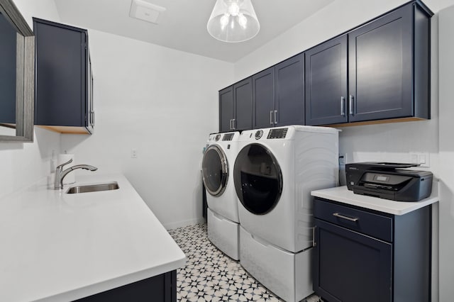 laundry room with sink, cabinets, and washer and dryer