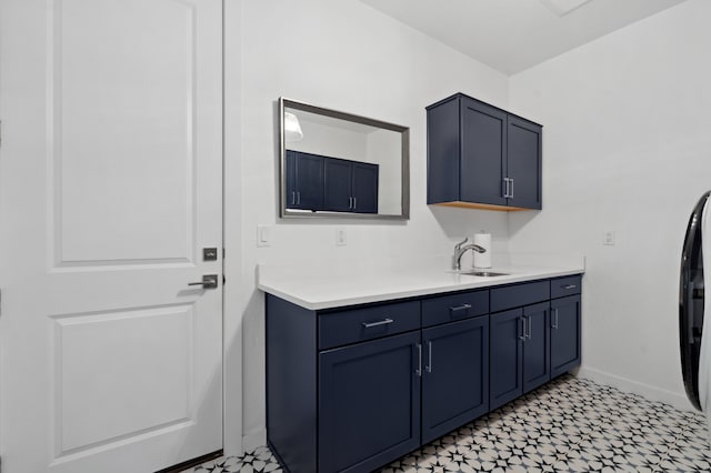 washroom with cabinets and sink