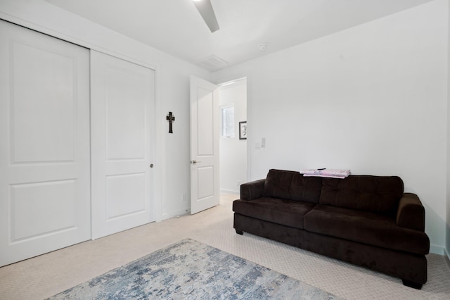 sitting room featuring light colored carpet and ceiling fan