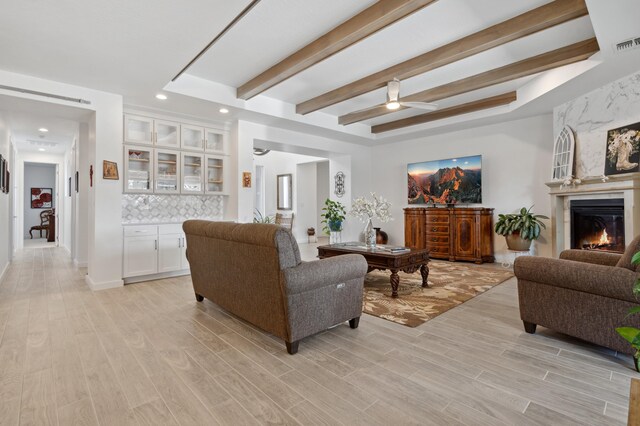 70 Camino De Claudio, Corrales, NM 87048 - living room featuring light wood-style floors, a fireplace, a ceiling fan, and beam ceiling