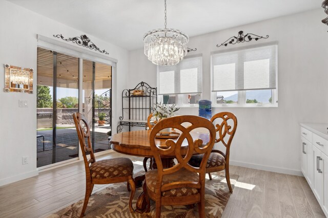 70 Camino De Claudio, Corrales, NM 87048 - dining room with baseboards, a notable chandelier, and light wood-style floors