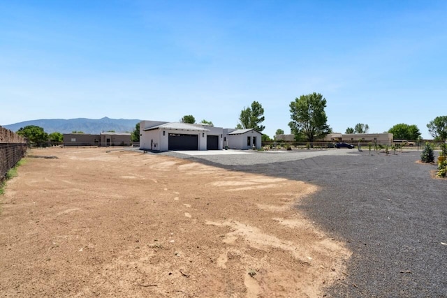 view of yard featuring a mountain view and a garage