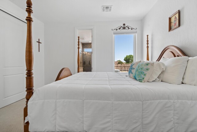 70 Camino De Claudio, Corrales, NM 87048 - carpeted bedroom featuring visible vents and connected bathroom