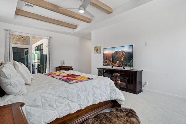 carpeted bedroom with beamed ceiling and ceiling fan