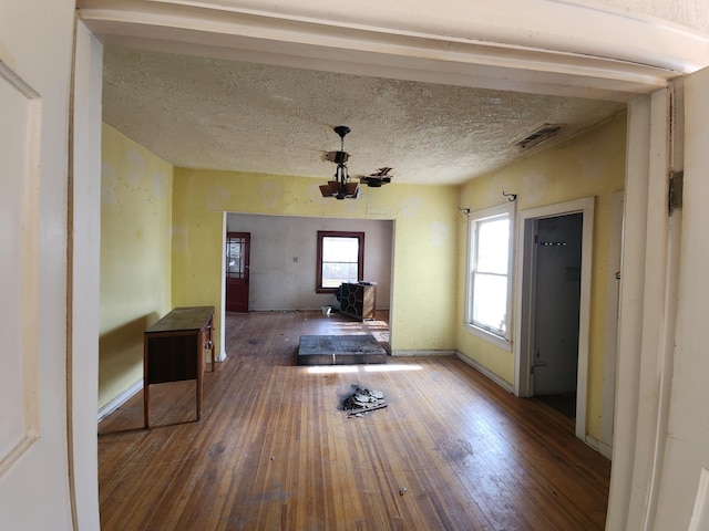 interior space featuring hardwood / wood-style flooring and a textured ceiling