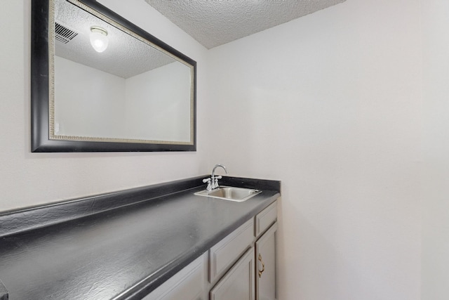 bathroom featuring vanity and a textured ceiling