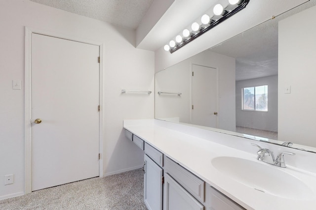 bathroom featuring vanity and a textured ceiling