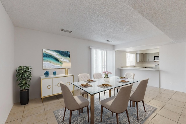 dining room with light tile patterned floors and a textured ceiling