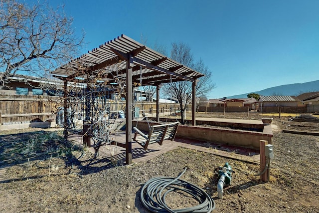 view of yard with a mountain view and a pergola