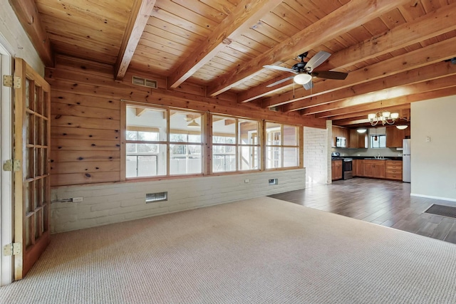 unfurnished living room featuring wood ceiling, ceiling fan with notable chandelier, sink, and beamed ceiling