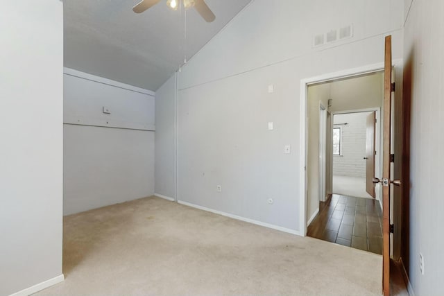 carpeted spare room with high vaulted ceiling and ceiling fan