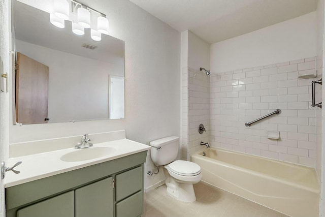 full bathroom featuring tiled shower / bath, vanity, and toilet