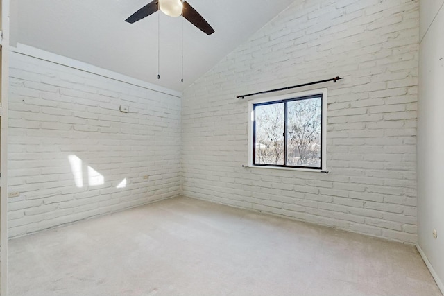 spare room featuring vaulted ceiling, light colored carpet, and ceiling fan