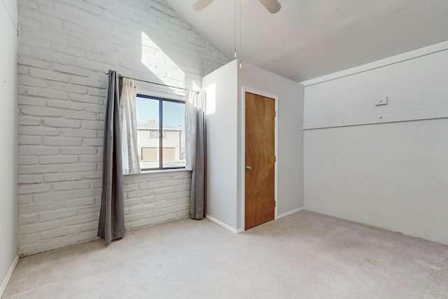 bonus room with ceiling fan, brick wall, vaulted ceiling, and light carpet