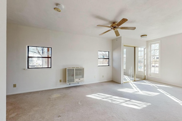 interior space featuring ceiling fan, light carpet, and heating unit