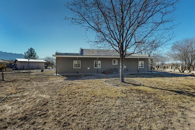 rear view of property featuring a yard