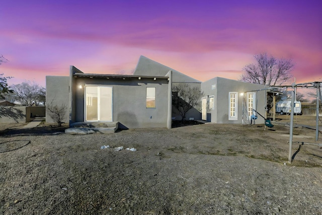 view of back house at dusk