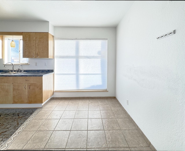 kitchen featuring sink and light tile patterned floors