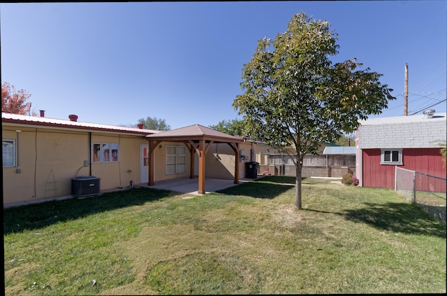 view of yard featuring a gazebo, central air condition unit, and a storage unit