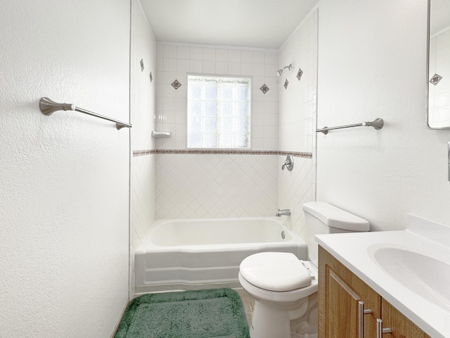 full bathroom with vanity, toilet, and tiled shower / bath combo