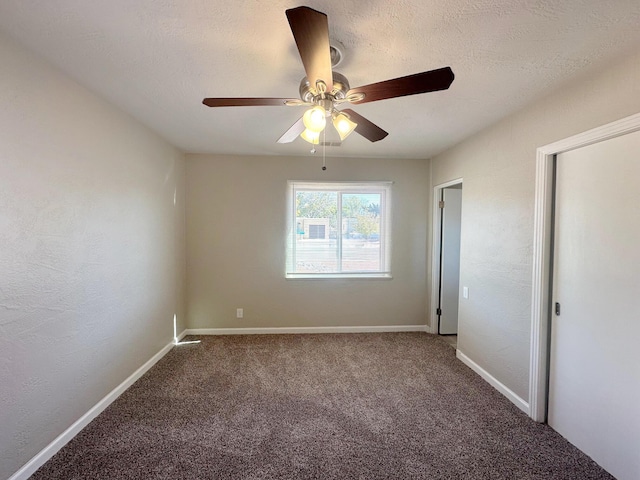 unfurnished bedroom with baseboards, a ceiling fan, a textured wall, a textured ceiling, and carpet floors