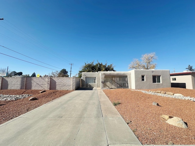 view of front of property with fence and stucco siding