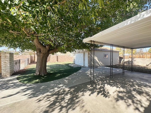 view of patio with an outbuilding and a fenced backyard