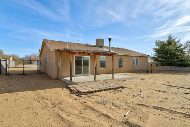 rear view of property with central air condition unit, stucco siding, fence, and a patio