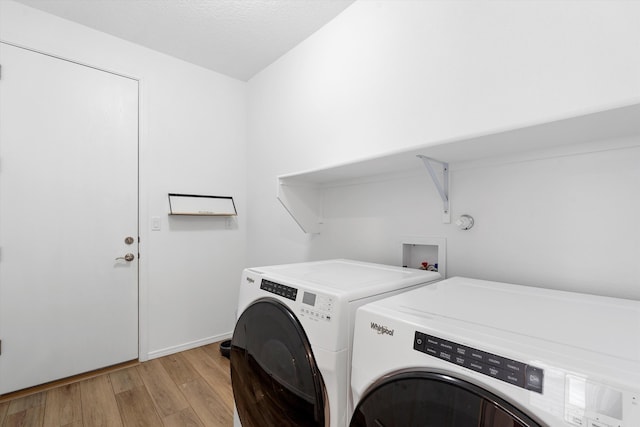 washroom featuring light hardwood / wood-style flooring and washer and dryer