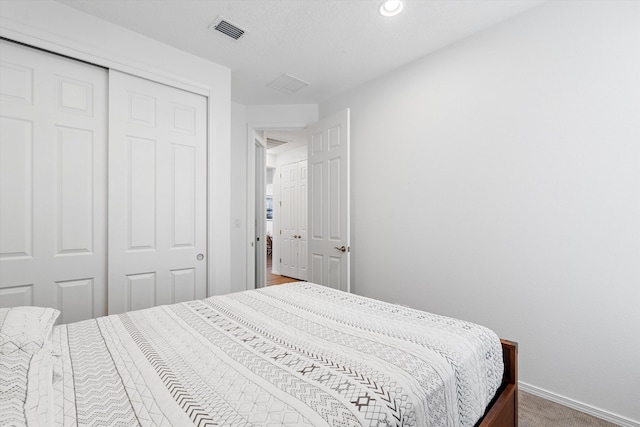 bedroom with carpet and a closet