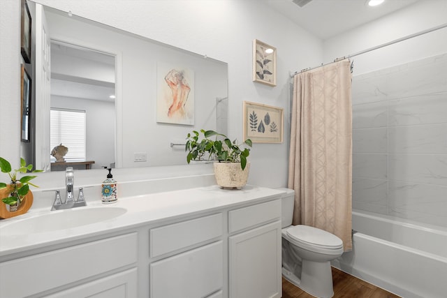 full bathroom with vanity, hardwood / wood-style floors, toilet, and shower / tub combo with curtain