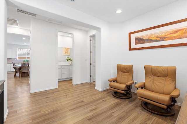 sitting room featuring light hardwood / wood-style flooring