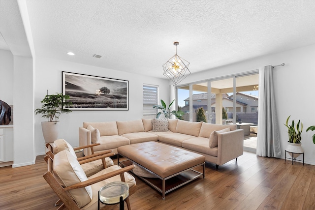 living room featuring hardwood / wood-style floors and a textured ceiling