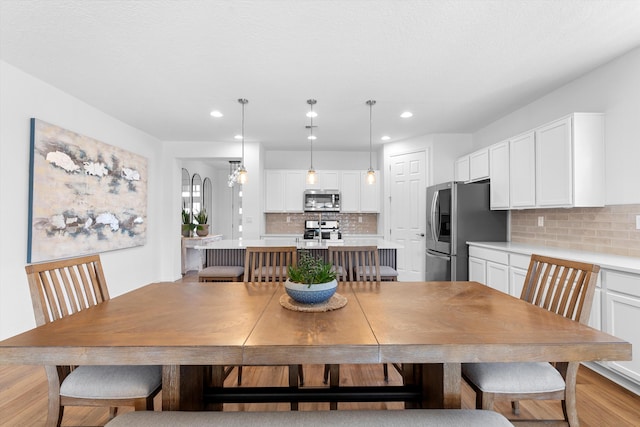 dining area featuring light wood-type flooring