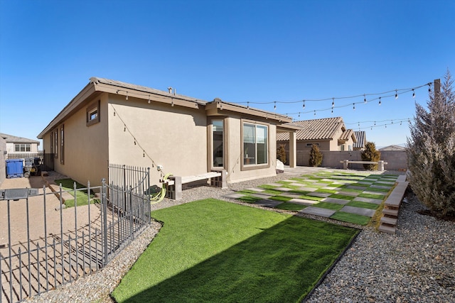 rear view of house with a patio and a lawn