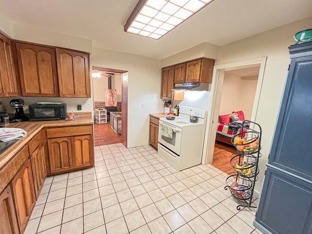 kitchen featuring light tile patterned floors and white range with electric stovetop