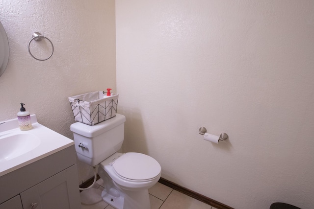 bathroom featuring vanity, tile patterned floors, and toilet