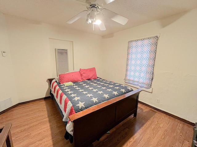 bedroom featuring hardwood / wood-style flooring and ceiling fan