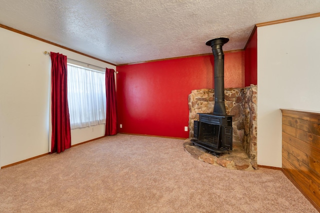 unfurnished living room with light carpet, ornamental molding, a textured ceiling, and a wood stove