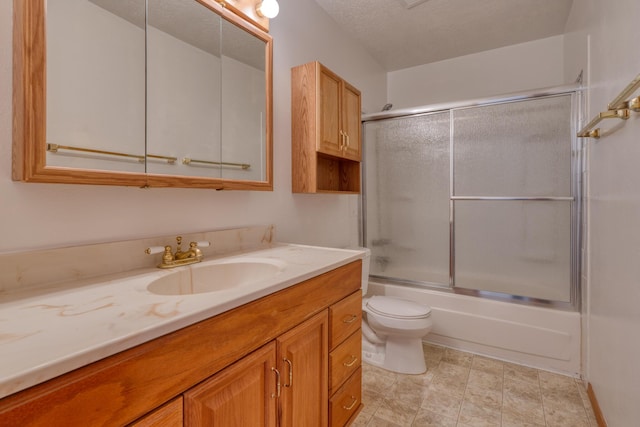 full bathroom featuring enclosed tub / shower combo, vanity, toilet, and a textured ceiling