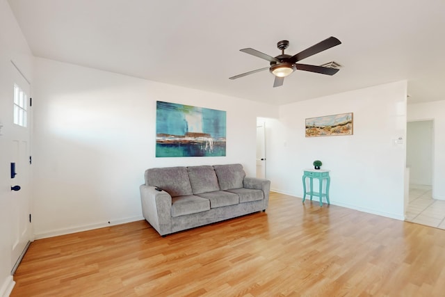 living room with ceiling fan and light hardwood / wood-style flooring