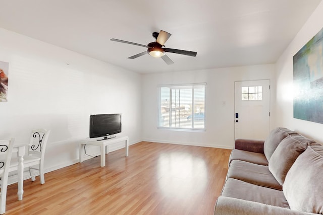 living room with light hardwood / wood-style flooring and ceiling fan