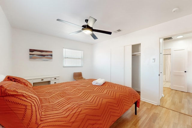 bedroom with light hardwood / wood-style flooring, a closet, and ceiling fan