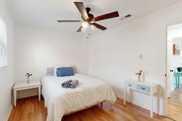 bedroom with ceiling fan and light wood-type flooring