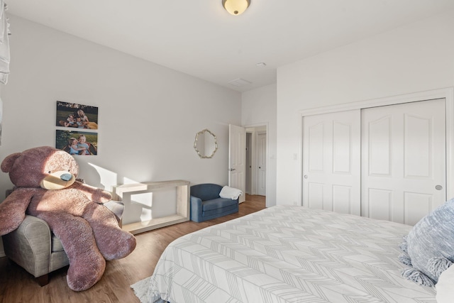 bedroom featuring light hardwood / wood-style flooring and a closet